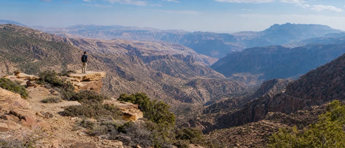 The stone village of Dana perched on a cliff edge overlooking the vast Dana Biosphere Reserve valley